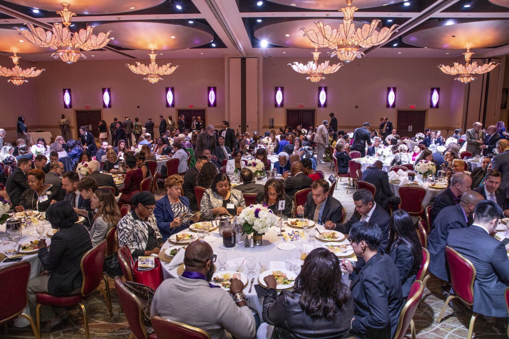 A large room full of people at a banquet.