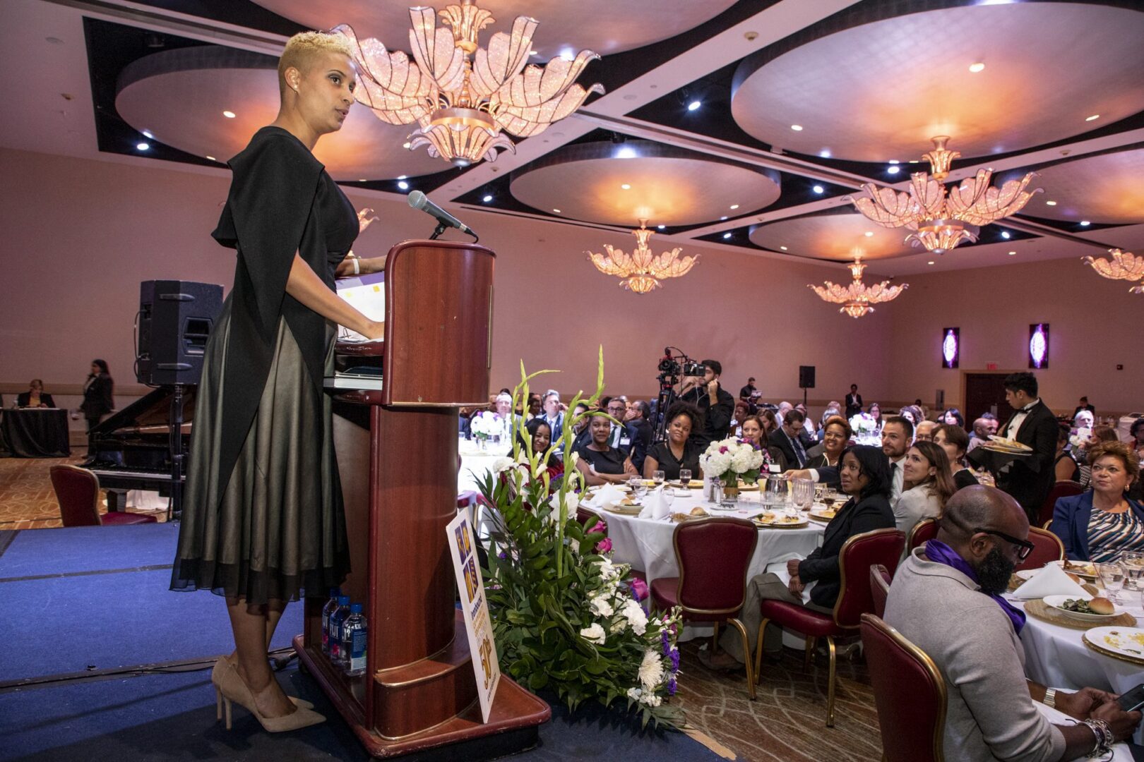 A woman giving a speech at a banquet.